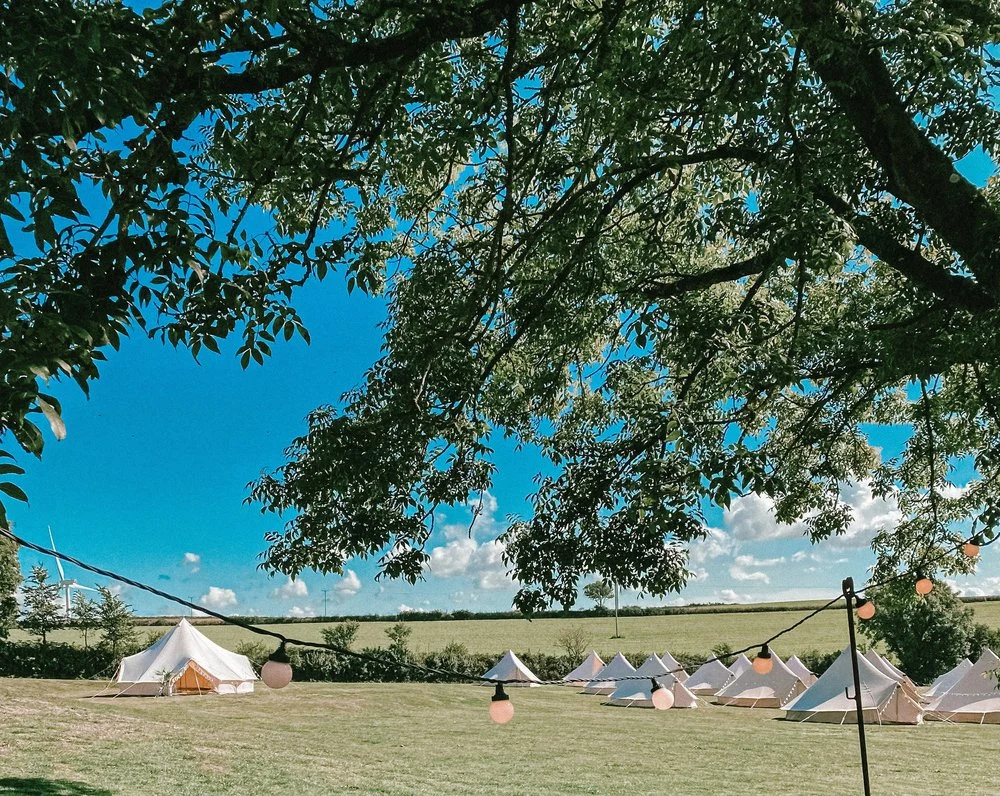 Blank Canvas bell tent village in an open field